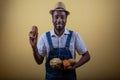 An African farmer holds cocoa beans in his hand, he is happy for the good harvest Royalty Free Stock Photo