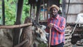 African farmer man feeding grass for a cows in the farm .Agriculture or cultivation concept Royalty Free Stock Photo