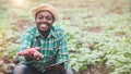 African farmer man holding fresh sweet potato at organic farm with smile and happy.Agriculture or cultivation concept Royalty Free Stock Photo