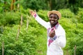African farmer man standing in the organic farm with wearing native clothes . Agriculture or cultivation concept Royalty Free Stock Photo