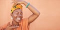 African, fashion and face of black woman on orange wall background with natural beauty, makeup and smile. Culture, hands