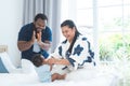 African father and Asian mother cheer up cute newborn baby playing sit up exercise on bed, smiling looking at innocent infant with Royalty Free Stock Photo