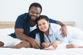 African father and Asian mother touching and lull cute newborn baby sleeping lying on bed at home, parent smiling looking at Royalty Free Stock Photo