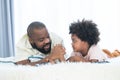 African father and child son holding hands and looking at each other after playing online video games, using joysticks or game Royalty Free Stock Photo