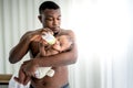 African father feeding milk from bottle milk to his baby newborn daughter Royalty Free Stock Photo