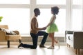 African father got down on one knee hold daughter hands Royalty Free Stock Photo