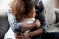 African father and little daughter embracing at home