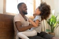 African father tickles little daughter family having fun indoors Royalty Free Stock Photo