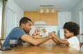 African father and son arm wrestling