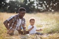 African father and son playing with soap bubbles outdoors Royalty Free Stock Photo