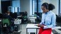 African female call center employee using smartphone. Royalty Free Stock Photo