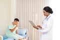 African female doctor typing on a laptop computer while sitting at a desk at work At the hospital office. Royalty Free Stock Photo