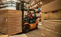 African female forklift operator moving stock around a warehouse Royalty Free Stock Photo