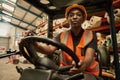 African female forklift operator at work in a textile warehouse Royalty Free Stock Photo