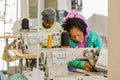 African female seamstresses working on hand-made garments on a sewing machine