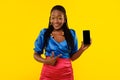 African Female Showing Smartphone Pointing At Screen On Yellow Background Royalty Free Stock Photo