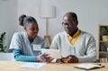 Volunteer helping elderly man to pay online Royalty Free Stock Photo