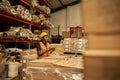 African female warehouse worker checking boxes using a digital tablet Royalty Free Stock Photo