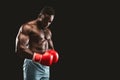 African fighter with red gloves on posing over black background