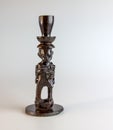 African figurine candlestick made of ebony on a white background Royalty Free Stock Photo