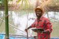 African fish farmer working with using tabket in the innovation farm.Agriculture or cultivation concept