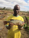 African fisherman holding fish