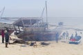 African fishermen set fire under Dhow to repair boat