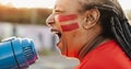 African football fan with painted face and megaphone cheering for her team Royalty Free Stock Photo