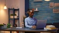 African freelancer working from home overtime at laptop Royalty Free Stock Photo