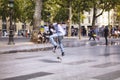 African French young male jumps while skating