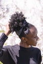 African girl on background of blossom tree outdoor Royalty Free Stock Photo