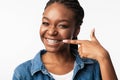 African Girl In Braces Pointing Finger At Smile, White Background Royalty Free Stock Photo