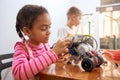 African girl creating robot. Royalty Free Stock Photo