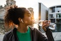 African girl drinking water during workout outdoors Royalty Free Stock Photo