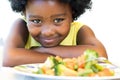 African girl in front of vegetable dish. Royalty Free Stock Photo