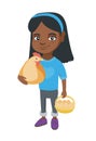 African girl holding a chicken and hen eggs.