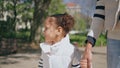 African girl holding hand unknown woman walking at park closeup. Family weekend