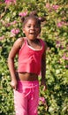 african girl with ponytails jumping in the garden