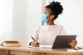 African Girl In Protective Mask Studying Using Tablet In Classroom