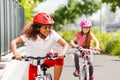 African girl racing on bicycle with her friend