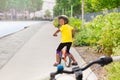 African girl riding bicycle on cycle lane in city