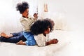 African girl siblings are having fun and tease each other in the bedroom during the holidays on watercolor illustration .