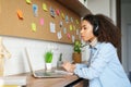 African girl student wear headphones distance learning watching video webinar. Royalty Free Stock Photo