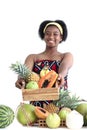 African girl teen with curly hair wearing traditional clothes, holding tropical basket fruits. Happy smiling African woman Royalty Free Stock Photo