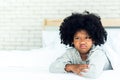 African girl 5-years old, Lying in the white bed Showing face Depicting anger and resentment