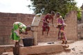 African Girls Having Trouble In Pumping Water Out Of An Almost Dry Public Well Royalty Free Stock Photo