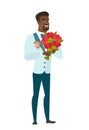 African groom holding a bouquet of flowers.