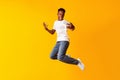 African guy jumping for connecting the internet on his cell phone Royalty Free Stock Photo