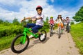 African guy rides bike with friends riding behind Royalty Free Stock Photo