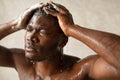 African Guy Washing Head With Eyes Closed Taking Shower Indoor Royalty Free Stock Photo